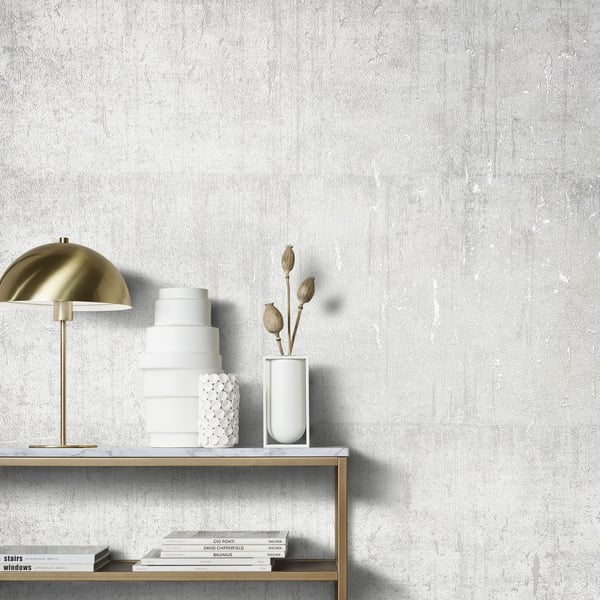 95028 -  Wallpaper Collection - White Colours - This aged concrete effect wallpaper is the perfect choice if you want to bring a room up to date in a dramatic way. With a subtle emboss to create some structural depth, it comes in an on-trend silver grey colourway. Drawing on the textures of, and resembling the stippled texture of ancient plasterwork or faded limestone, this unusual wallpaper will be a warming welcome to your home. This will be perfect on all four walls or can be accompanied by a complementary wallpaper. Design